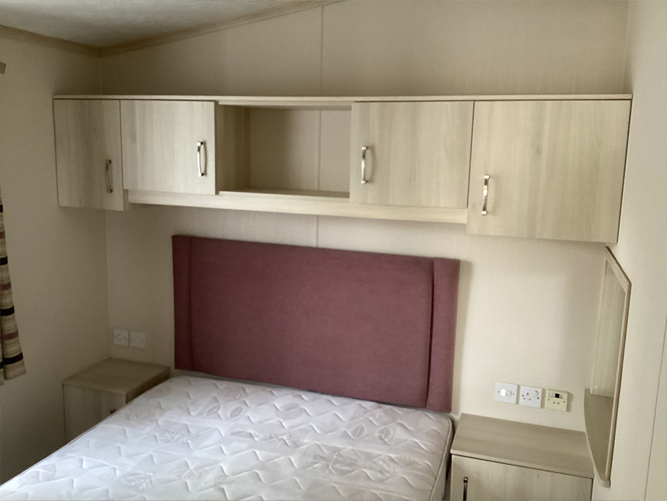 bed with cupboards above it